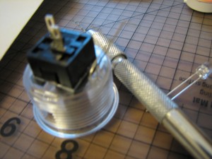 A certain drill, button, and LED.